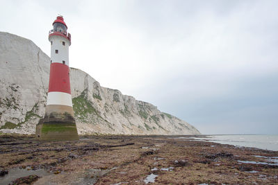 Beachy head lighthouse, seven sisters chalk cliffs at low tide near eastbourne, east sussex