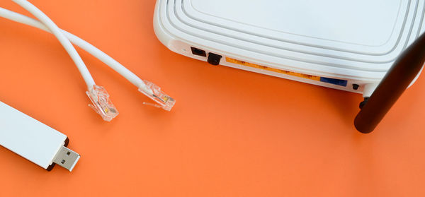 Close-up of router with cables on orange background