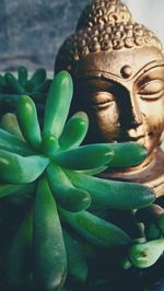 Close-up of buddha statue against building