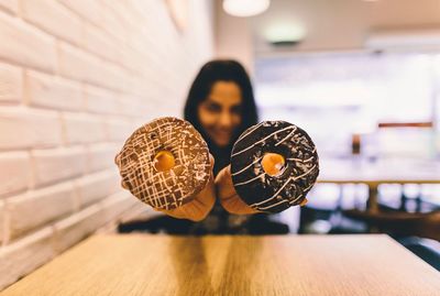 Woman showing donuts in restaurant