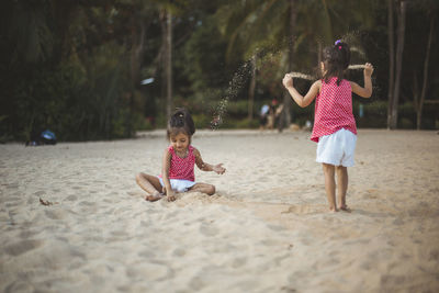 Rear view of women playing on sand