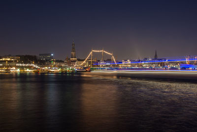 Illuminated city at waterfront