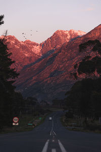 Road by mountain against sky