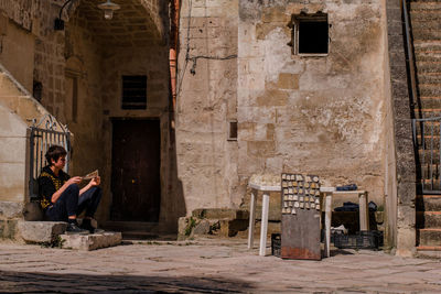 Man sitting in front of building