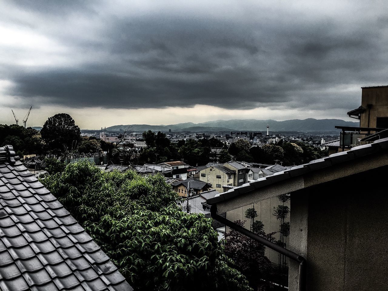 sky, cloud - sky, architecture, built structure, building exterior, cloudy, railing, cloud, weather, mountain, water, overcast, nature, high angle view, house, residential structure, landscape, sea, scenics, beauty in nature