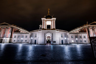 Illuminated building against sky in city at night