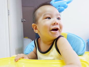 Cute baby boy sitting at home