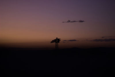 Silhouette tower against sky during sunset