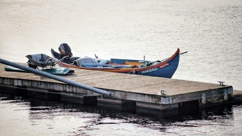 Side view of boats moored in lake