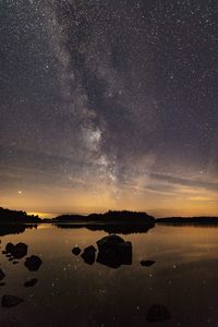 Scenic view of rocks against sky at night