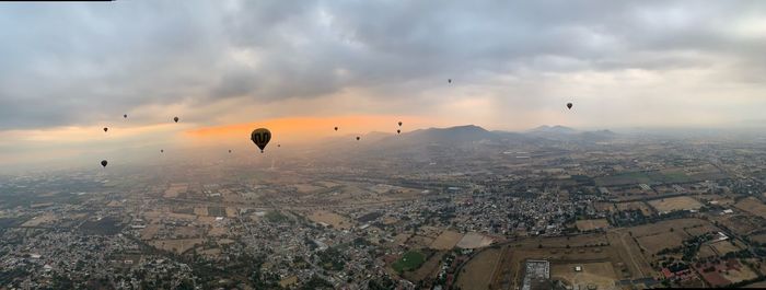 Aerial view of city against sky during sunset
