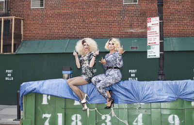 Two drag queens giving the finger