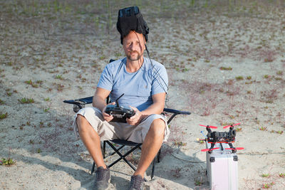 Portrait of man with drone on field