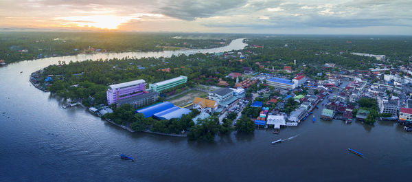 High angle view of city by river against sky