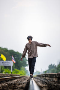 Man walk away on railroad with warm light. selective focus. traveler man on railroad. person