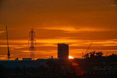 Silhouette buildings against sky during sunset