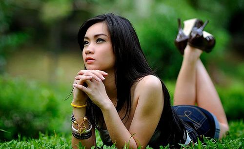 Young woman lying on field