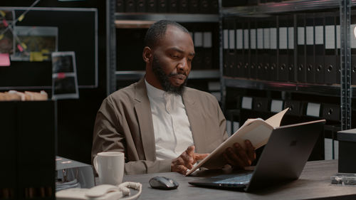 Senior man using laptop while sitting in office