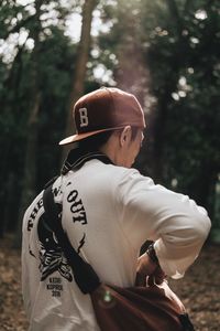 Rear view of man standing in forest