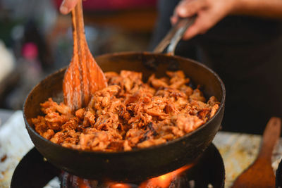 Midsection of person cooking food at market stall