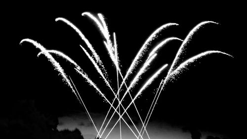 Low angle view of firework display at night