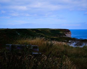 Scenic view of sea against cloudy sky