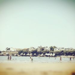 People at beach against sky