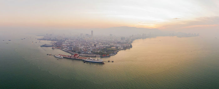 High angle view of ship in sea during sunset