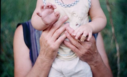 Midsection of woman holding baby