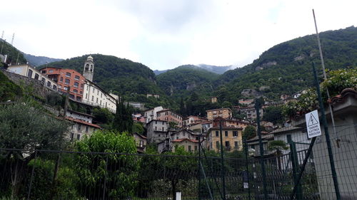 Houses in town against sky
