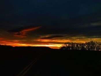 Scenic view of silhouette landscape against sky at night