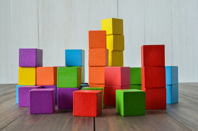 Close-up of multi colored toy blocks on wooden table