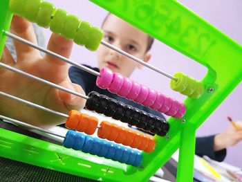 Boy counting colorful abacus
