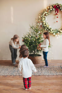 Full length of a girl holding christmas tree