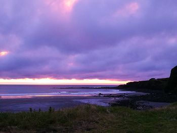 View of beach against cloudy sky