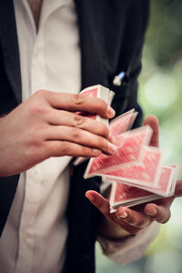 Midsection of man shuffling cards