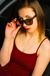 Portrait of confident beautiful woman in car