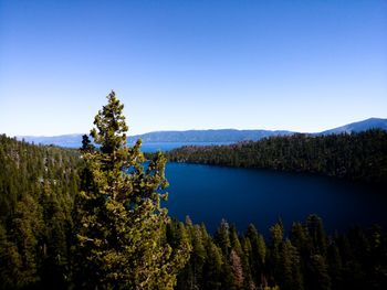 Scenic view of lake against clear blue sky