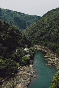 High angle view of river amidst mountains against clear sky