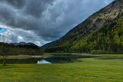 Scenic view of lake and mountains against sky