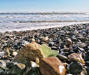 Rocks on beach against sky