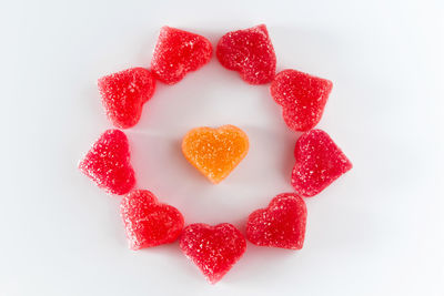 Close-up of heart shape cake against white background