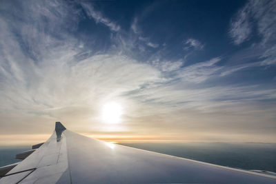 Aircraft's wing with beautiful sky from plane's window seat view.