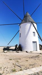 Traditional windmill against clear blue sky