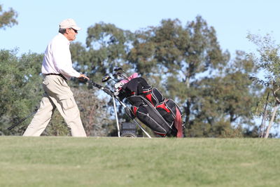 Man holding umbrella on field