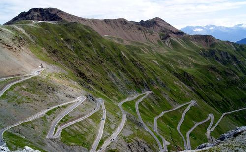 Scenic view of winding road on mountain against sky