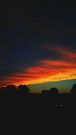 Silhouette landscape against dramatic sky