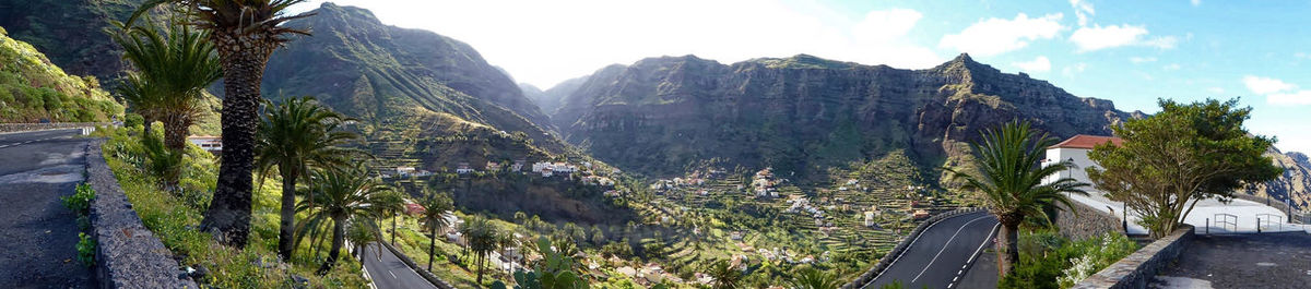 Panoramic view of trees and mountains against sky