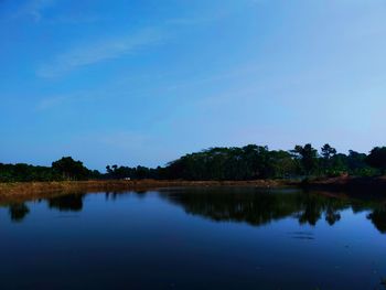 Scenic view of lake against blue sky