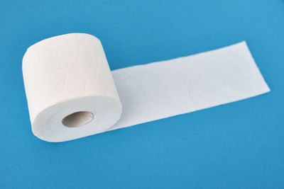 High angle view of white paper against blue background